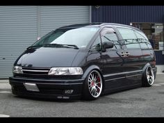 a black van parked in front of a garage