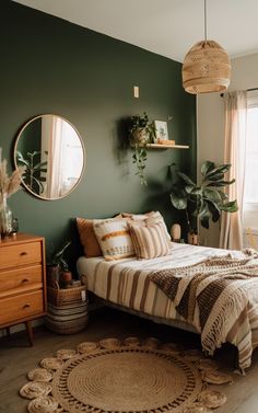 a bedroom with dark green walls and white bedding, round rugs on the floor