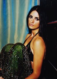 a beautiful young woman holding a green object