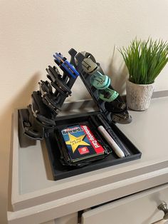 there is a black tray with scissors and other items on it next to a potted plant