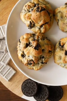 four chocolate chip cookies on a white plate