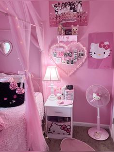 a bedroom decorated in pink with hello kitty decorations