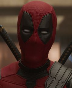 the deadpool character is dressed in red and black with two swords on his chest