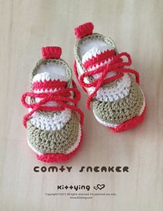 a pair of crocheted baby shoes sitting on top of a table