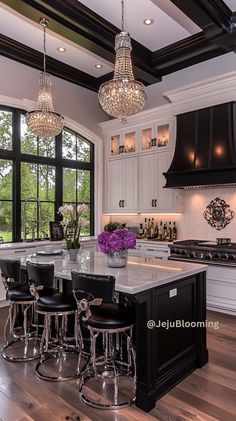 a large kitchen with an island and chandelier