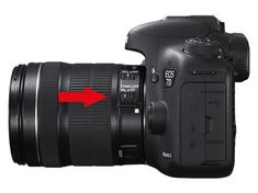 a camera with an arrow pointing to the lens on it's back side,