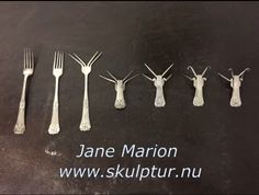 five forks and six spoons are arranged in the shape of antlers