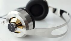 a pair of headphones sitting on top of a white table next to each other