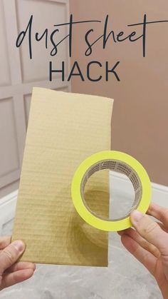 two hands holding a piece of paper with the words dust sheet hack on it