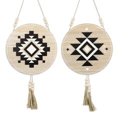 two circular wooden wall hangings with tassels and beaded accents, one in black and white