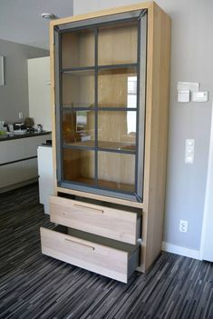 a wooden cabinet sitting on top of a hard wood floor