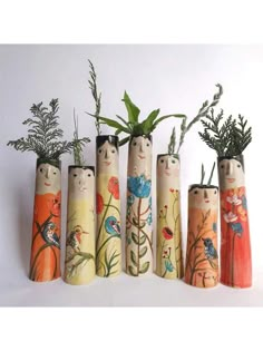 five wooden vases with plants in them