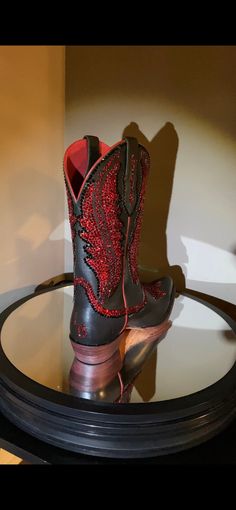 The Ariat® Tailgate cowgirl boots feature distressed leather, metallic finishes, and bold colors, making them ideal for wearing with skinny jeans, leggings, and dresses. This pair is blinged out with 9,000 red and black Swarovski crystals. Size 8 Premium full grain leather upper. Classic Western cowgirl boot with side leather pull loops for easy entry. Features unique Western-inspired stitch pattern on shaft and foot. Inside zipper for easy on and off. Leather lining for a comfortable fit. 4LR™ Cowgirl Boots Square Toed, Western Shoes, Cowgirl Boot, Western Cowgirl, Jeans Leggings, Western Cowboy Boots, Leather Pulls, And Dresses, Distressed Leather