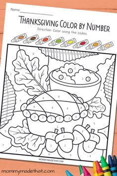 a thanksgiving color by number coloring page with markers and crayons on the table