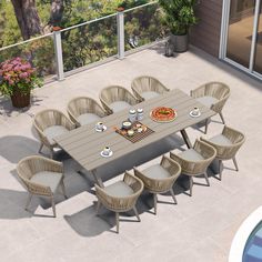 an outdoor dining table and chairs on a patio with a swimming pool in the background