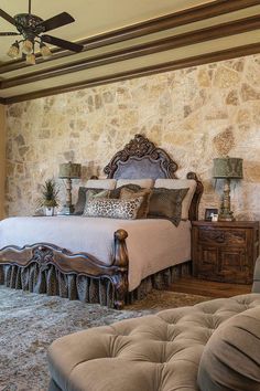 a bedroom with stone walls and an ornate bed