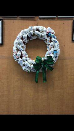 a wreath made out of bottles is hanging on the wall