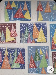 colorful paper christmas trees are displayed on the wall