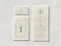 the wedding stationery is laid out on top of each other