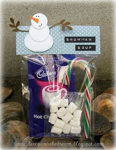 a bag filled with marshmallows, candy canes and a snowman