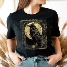 Gothic Raven Shirt, Tarot Card Shirt, Goblincore Shirt, Vintage T-Shirt, Witchy Shirt, Crow, Dark Academia Shirt. 📣 INFORMATION * All shirts are UNISEX * 100% Airlume combed and ringspun cotton (fiber content may vary for different colors) * Wash and dry normally (on cool for best results) 👕 SIZING * For an oversized fit, select two or three sizes up from your normal size * Model is wearing size L * Sizing runs true to size * Most women find their typical size works best, since they are meant Goblincore Shirt, Dark Academia Shirt, Gothic Raven, Tarot Card Shirt, Witchy Shirt, Tarot Card, Dark Academia, Tarot Cards, Vintage Tshirts