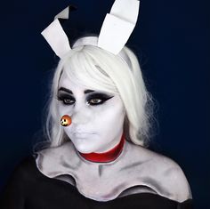 a woman with white makeup and bunny ears