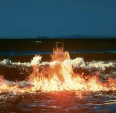 a fire hydrant spewing out flames into the ocean