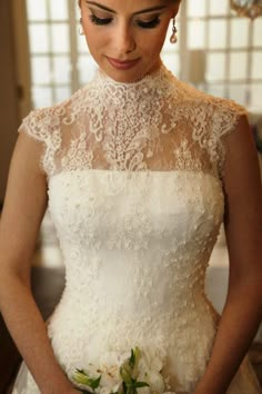 a woman in a wedding dress holding a bouquet