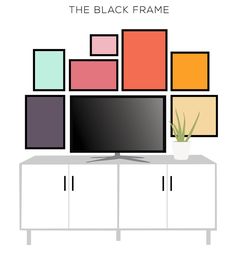 a flat screen tv sitting on top of a white cabinet next to a potted plant