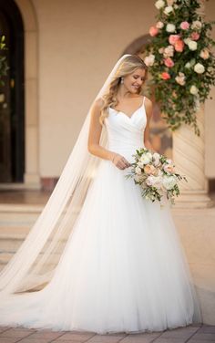 a woman in a wedding dress holding a bouquet