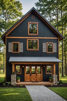 a black house with wood trim and windows