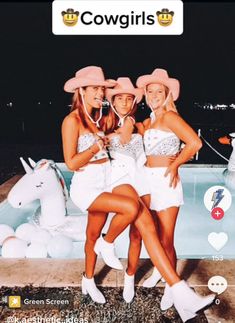 three girls in white outfits standing next to a pool with an unicorn on the side