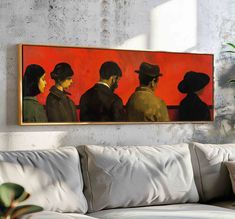 a painting hanging on the wall above a couch