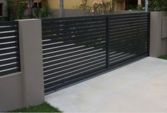 a modern fence is shown in front of a house