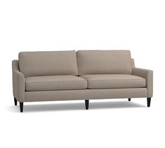 a gray couch sitting on top of a white floor