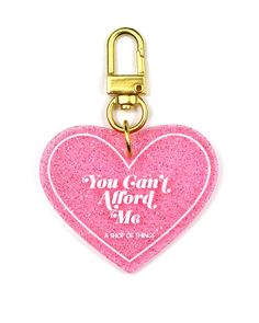 a pink heart shaped key chain with the words you can't afford me on it