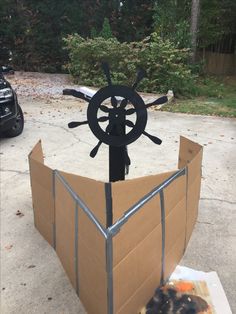 a cardboard boat made to look like a steering wheel