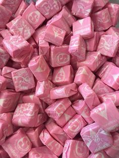 a pile of pink and white candy cubes