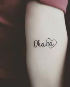 a woman's arm with the word ohana written in cursive font