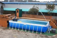 an above ground swimming pool surrounded by wooden decking