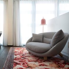 a living room with a chair and rug in it