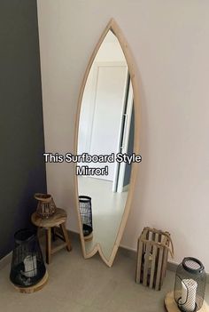 a mirror sitting on top of a wooden shelf next to a lamp and other items