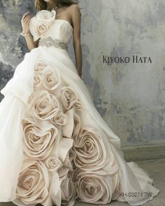 a woman in a wedding dress with roses on it