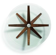 a white plate topped with a wooden and glass star shaped object on top of it