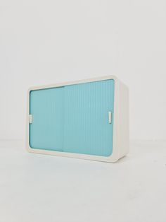 a white and blue cabinet sitting on top of a table