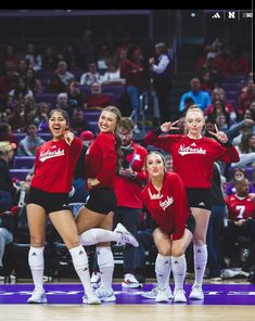 the cheerleaders are posing for a photo on the court in front of an audience