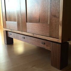 a wooden cabinet sitting on top of a hard wood floor