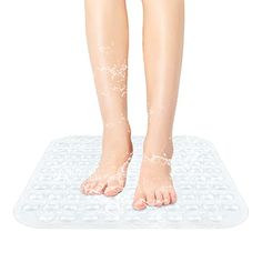 a woman standing on top of a bath mat with her bare feet covered in water