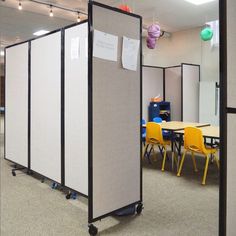 a room divider in an office with chairs and desks on the other side