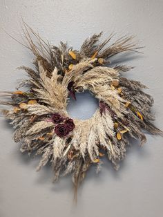 a dried wreath hanging on the wall